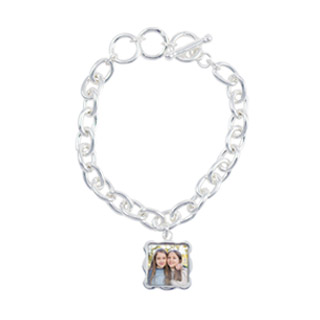 Bracelets 2: A silver link charm bracelet with a square, wavy-edged photo charm of two young women.