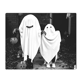 High Gloss Desk Art: An easel-back desk print with a black and white photo of two people in ghost costumes.