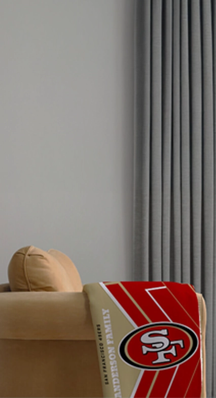 Personalized NFL photo blanket with team logo and custom family name.