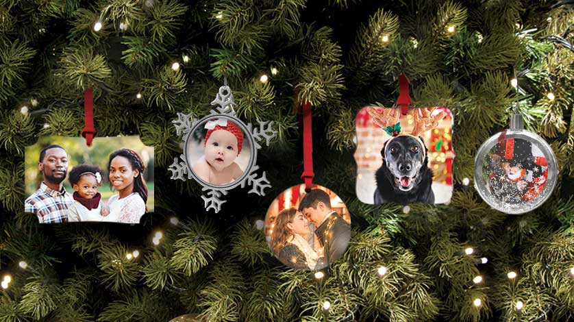 A variety of five different personalized photo ornaments hanging on a Christmas tree.