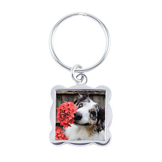 Wave Keychain: A square silver keychain with wavy edges and a photo of a dog.