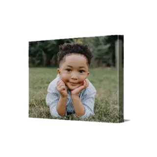 Canvas Prints: A landscape canvas print with a full-bleed photo of a boy lying in the grass.