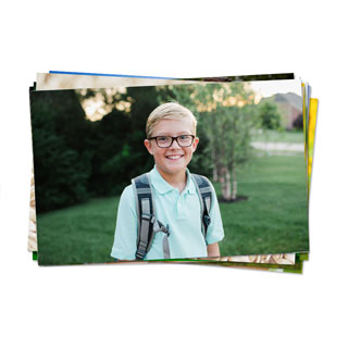 Stack of premium photo prints preserving school photo gifts and first day memories.