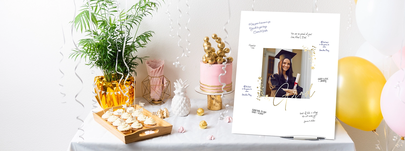 Guest Sign Grad Smiles: A white board print guest book featuring a graduate's photo and the word Grad in gold script, surrounded by handwritten congratulatory messages on a party table.