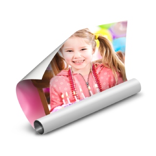Posters: A partially rolled photo poster of a young girl with her birthday cake.