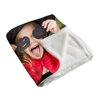 Plush Blankets: A folded photo blanket showing a picture of a girl in a Halloween costume on the front and the soft fleece backing.