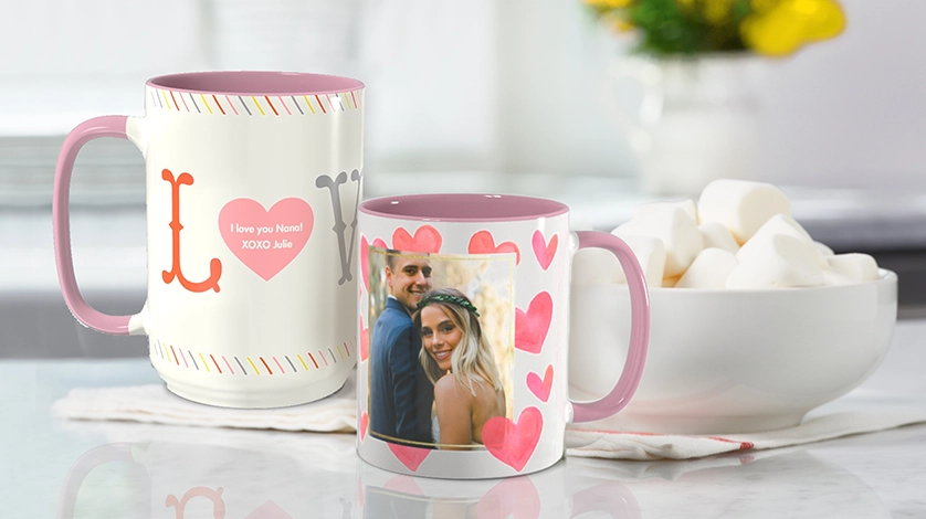 Personalized Mugs: Two personalized mugs with pink interiors, one for a Nona and one with a wedding photo.