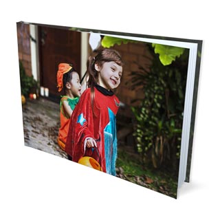 Hardcover Photo Books: A hardcover photo book with a full wrap-around photo of children trick-or-treating.