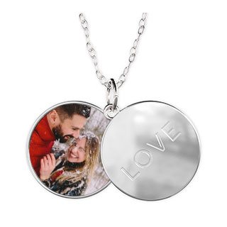 Sliding Locket Love: An open silver sliding locket with a photo of a couple on one side and the word love on the other.
