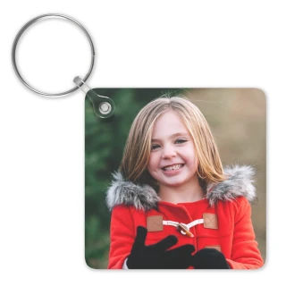 Double Sided Keychains: A square keychain with a full-bleed photo of a smiling girl in a winter coat.