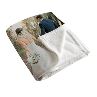 Blankets: A folded photo blanket showing a wedding picture on the front and the soft fleece backing.