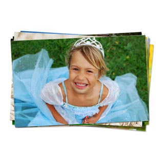 Prints: A stack of photo prints with the top photo showing a young girl in a princess costume.