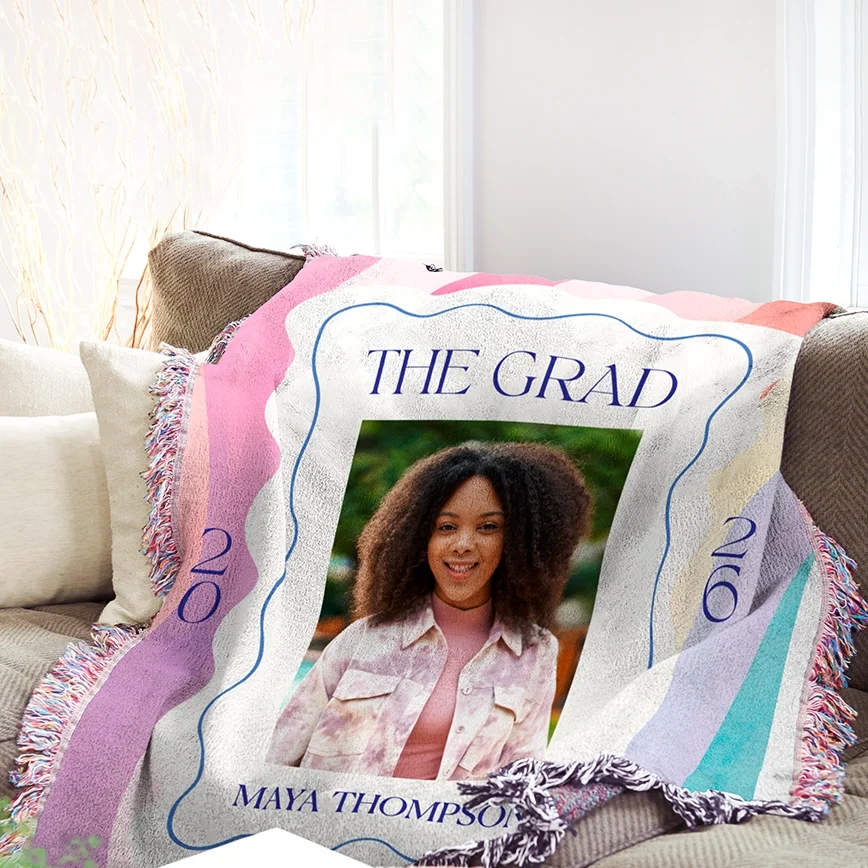 A personalised photo blanket draped in a cosy living room setting, showcasing a custom print design