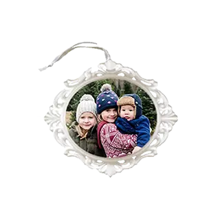 Ornaments: An ornate white oval ornament with a photo of three children.