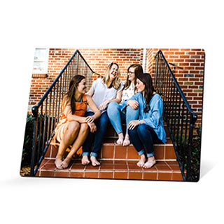 High Gloss Desk Art: An easel-back desk print with a photo of four female friends sitting on steps.