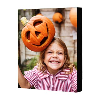 Mounted Prints: A vertical mounted print with a photo of a girl balancing a jack-o-lantern on her head.