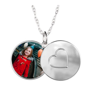 Sliding Locket Heart: An open silver sliding locket with a photo of a young girl on one side and an engraved heart on the other.