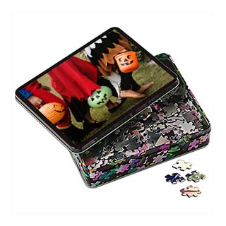 Puzzles: A personalized Halloween jigsaw puzzle in a decorative tin with a photo of children in costume.