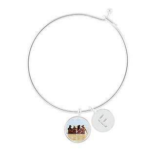 Charm and Letter Bangle: A silver charm bracelet with a circular photo charm and an initial charm.