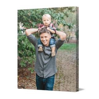 Canvas Prints: A vertical canvas print with a full-bleed photo of a child on their father's shoulders.