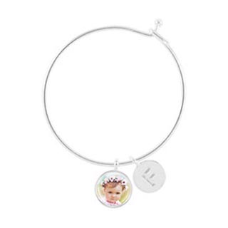 Charm Bracelets: A silver charm bracelet with a circular baby photo charm and an initial charm.