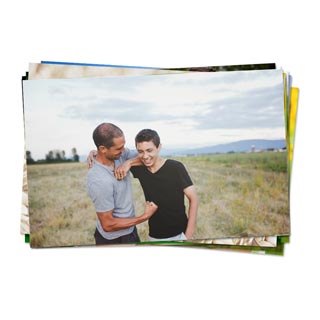 Prints: A stack of photo prints with the top photo showing a father and his teenage son.
