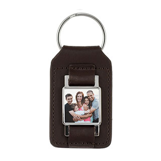 Leather Keychain: A brown leather keychain with a small square photo of a family.