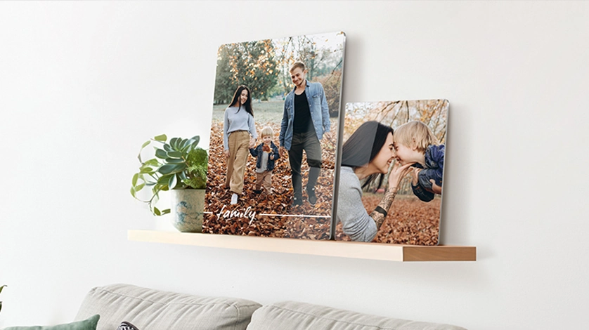 Modern high-definition metal prints for walls displayed on a wooden shelf with festive décor.