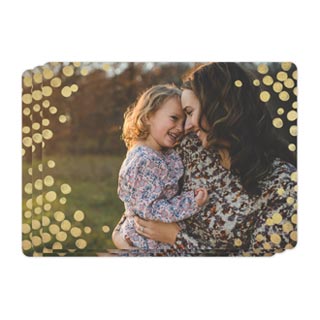 Magnets: A stack of photo magnets with the top one showing a mother and daughter, framed with golden bokeh lights.