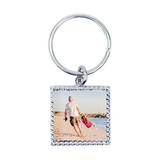 Keychains: A square keychain with a rope-textured border and a photo of an adult and child on the beach.