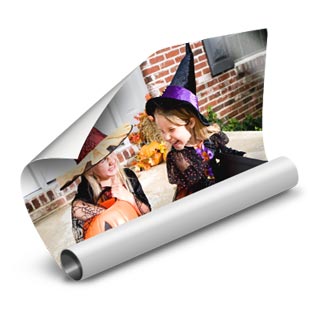 Posters: A partially rolled photo poster of two girls in witch costumes on Halloween.