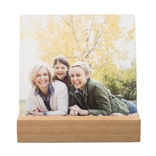 Metal Desk Art: A desktop metal print of three generations of women, displayed in a wooden block stand.