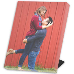 Same Day Desk Canvas: An easel-back canvas print with a full-bleed photo of a couple in front of a red barn.